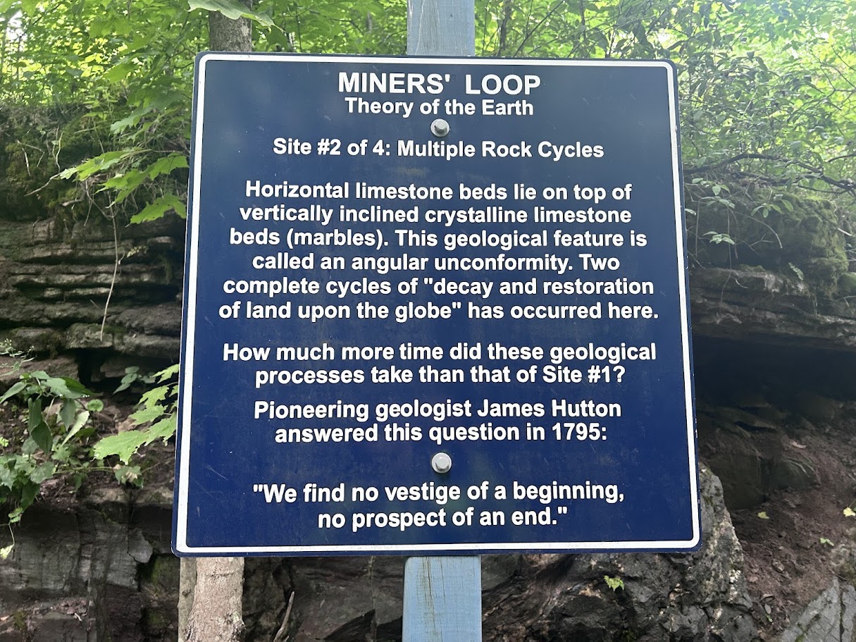 An interpretive geology sign on the Miners' Loop trail near the Marmora Mine