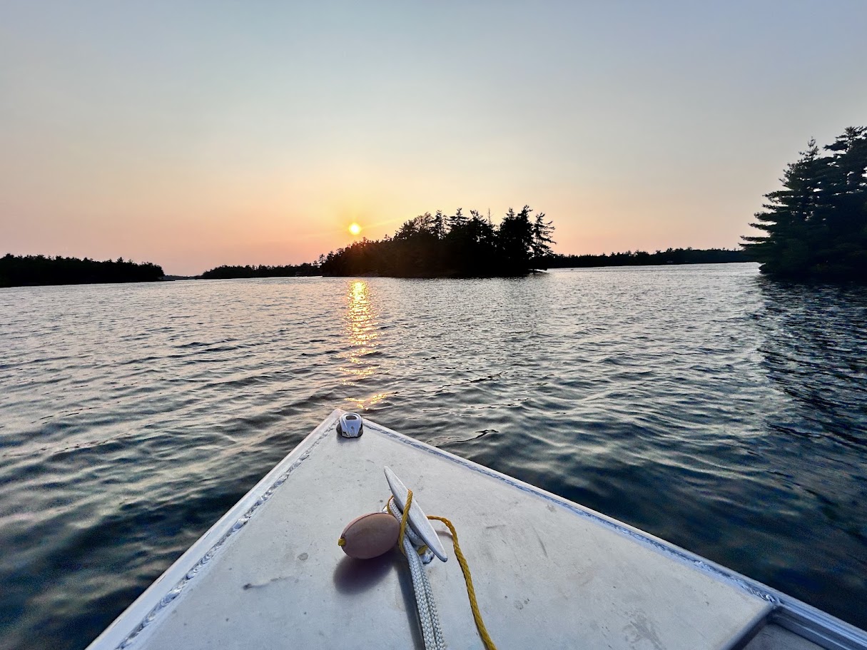 Sunset from the bow of a boat crossing Kasshabog Lake toward the cottage